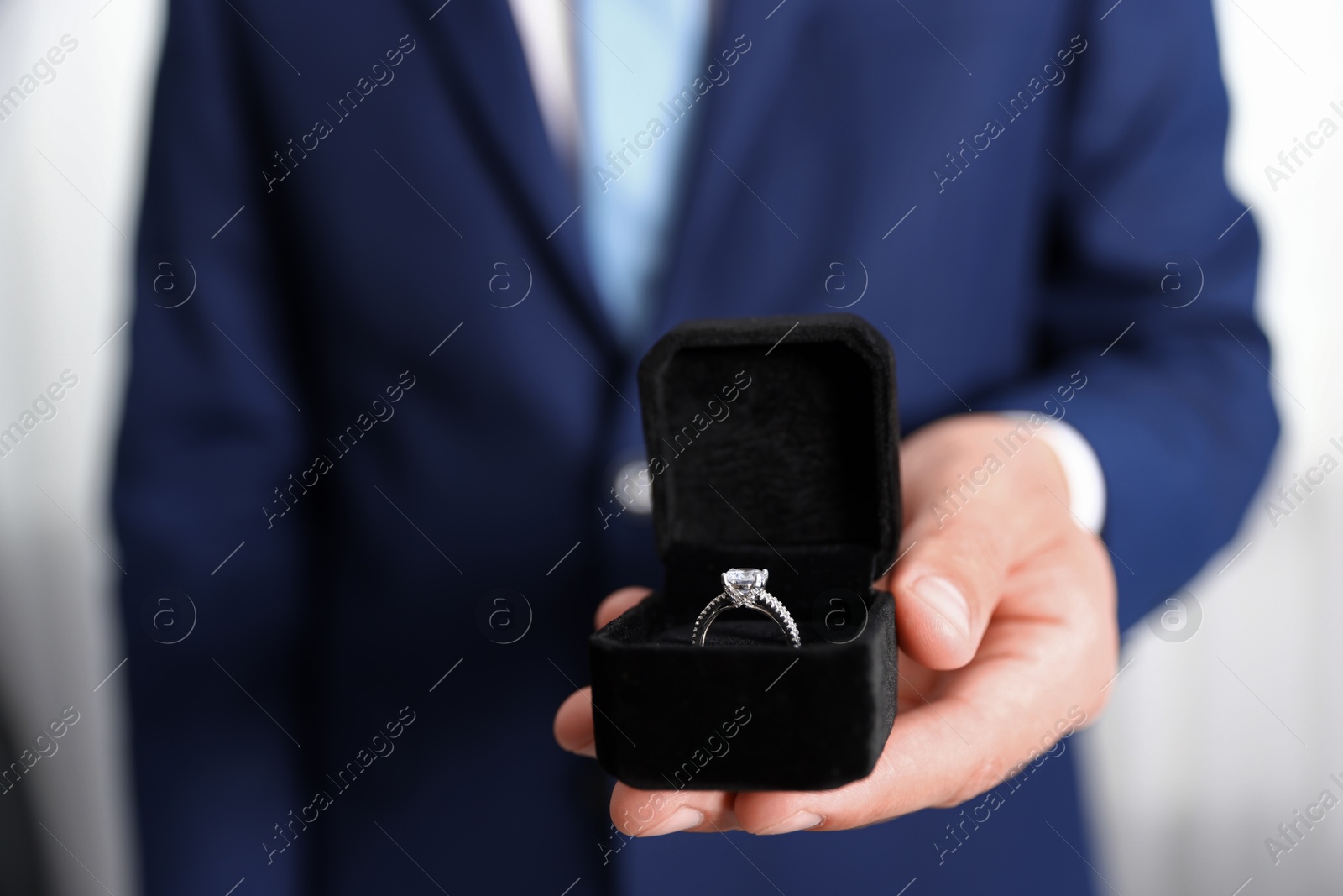 Making proposal. Man with engagement ring indoors, closeup Photo of Making proposal. Man with engagement ring indoors, closeup
