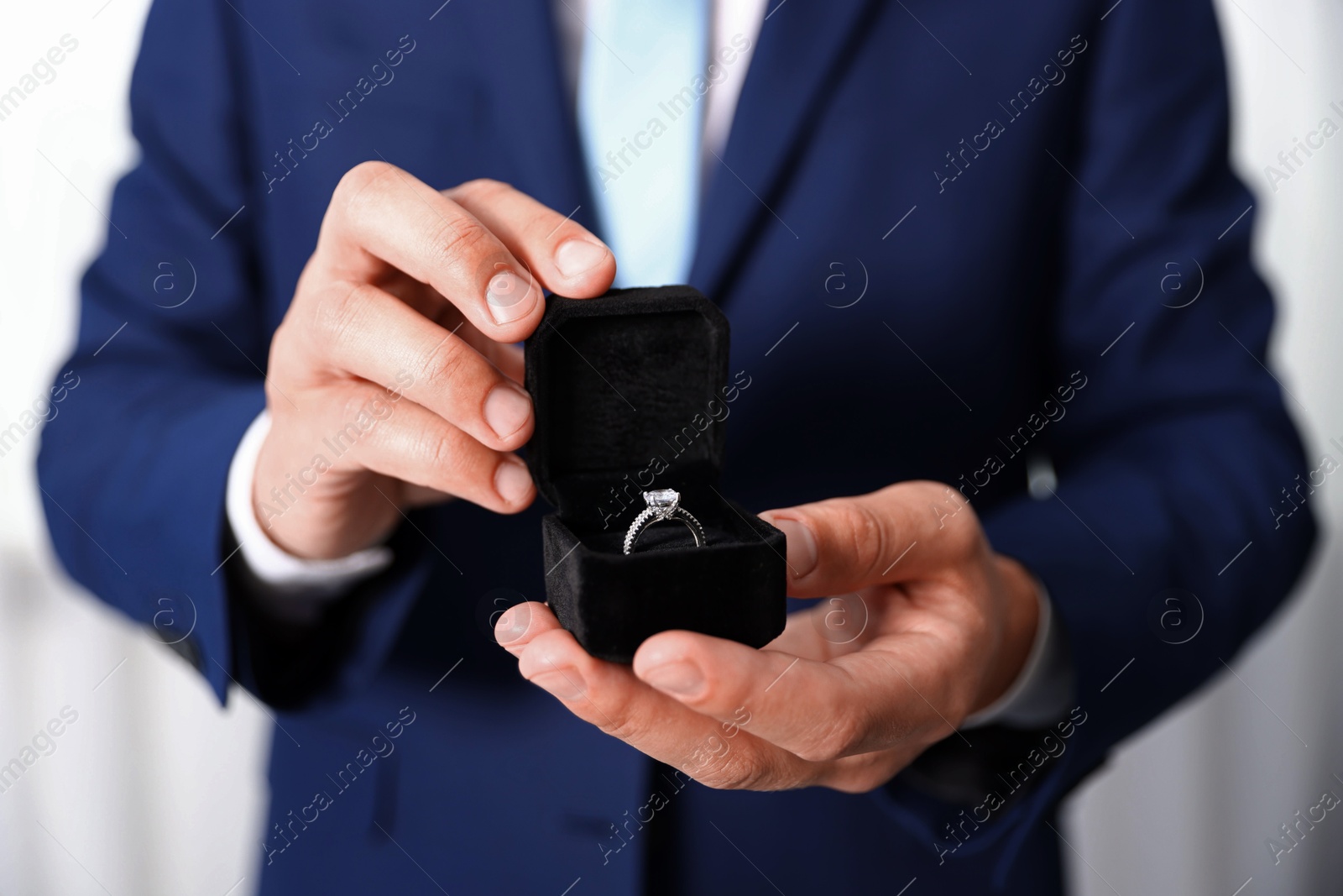 Making proposal. Man with engagement ring indoors, closeup Photo of Making proposal. Man with engagement ring indoors, closeup