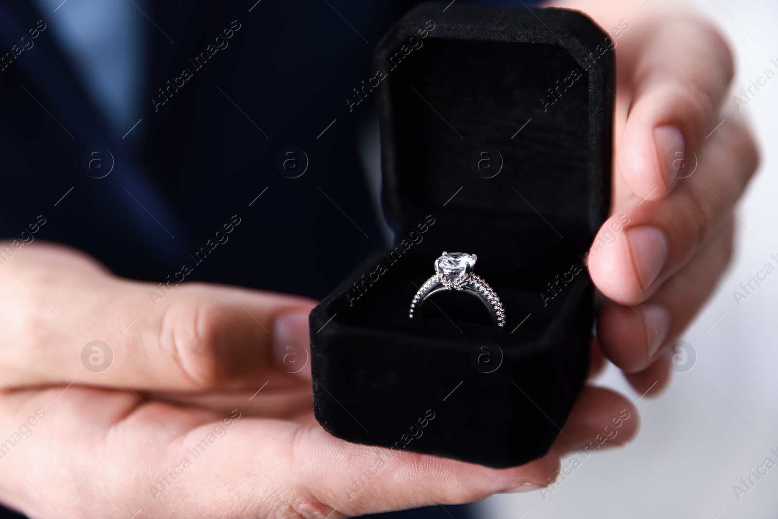 Making proposal. Man with engagement ring indoors, closeup Photo of Making proposal. Man with engagement ring indoors, closeup