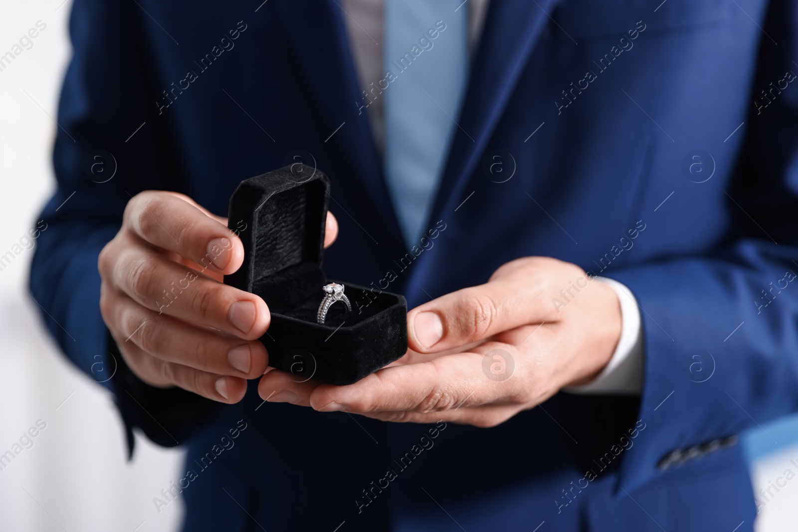 Making proposal. Man with engagement ring indoors, closeup Photo of Making proposal. Man with engagement ring indoors, closeup