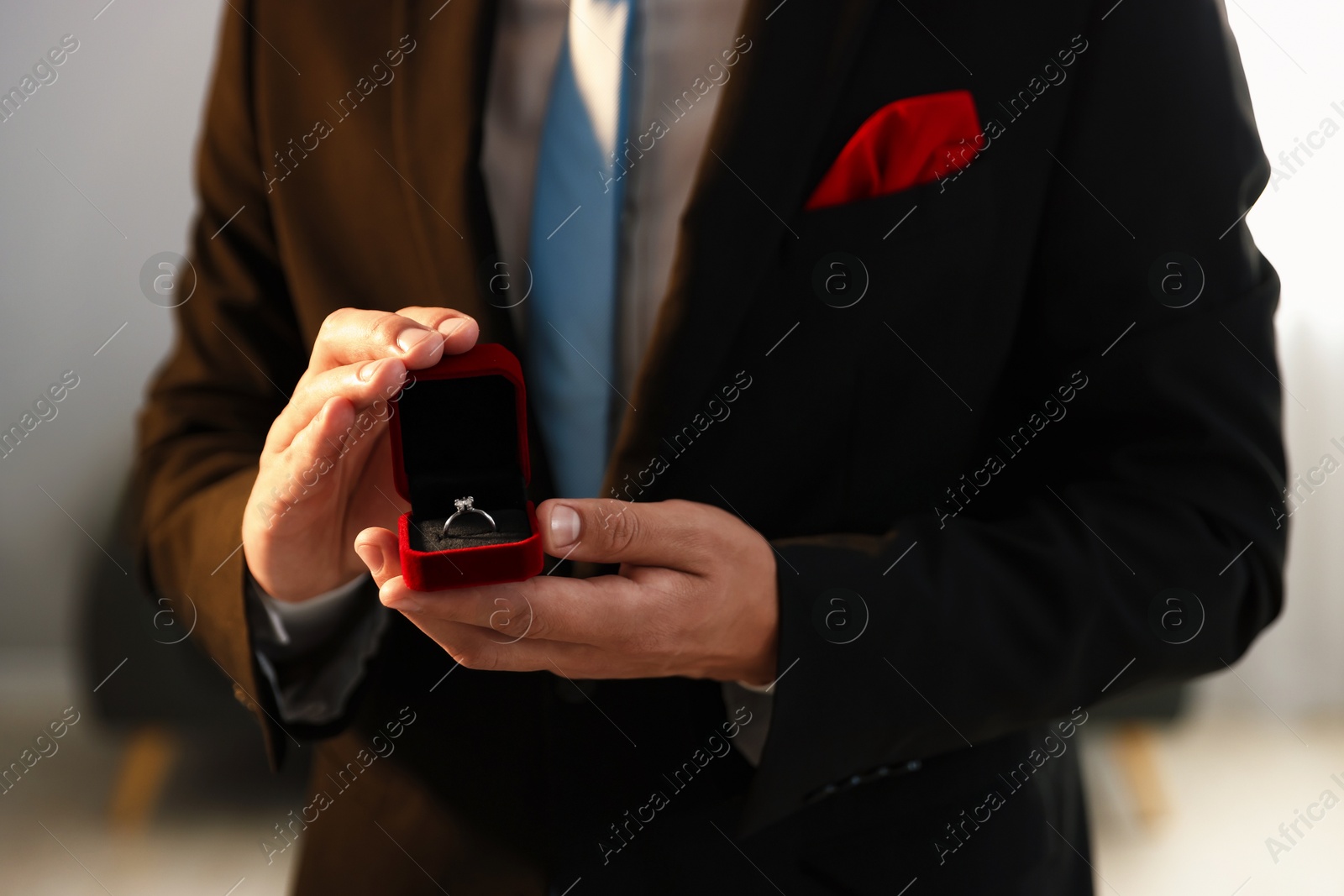 Making proposal. Man with engagement ring indoors, closeup Photo of Making proposal. Man with engagement ring indoors, closeup