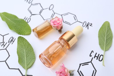 Photo of Bottles of cosmetic products, herbs and roses on paper with chemical formulas, closeup