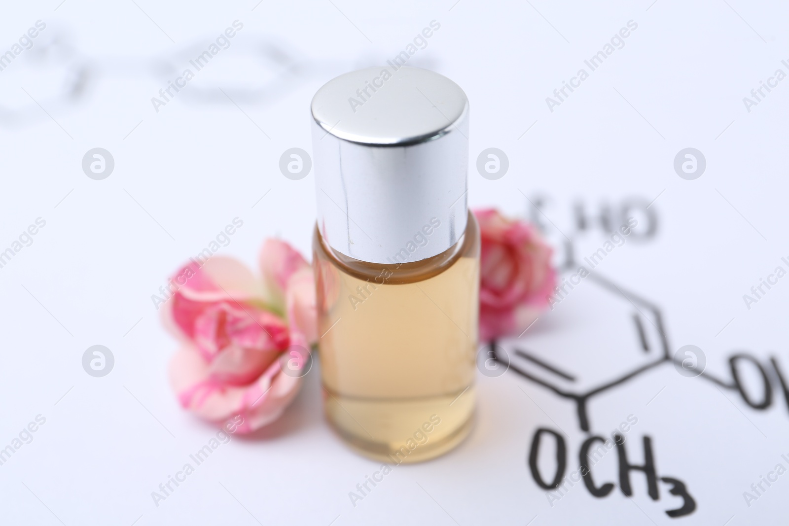 Photo of Bottle of cosmetic product and roses on paper with chemical formulas, closeup