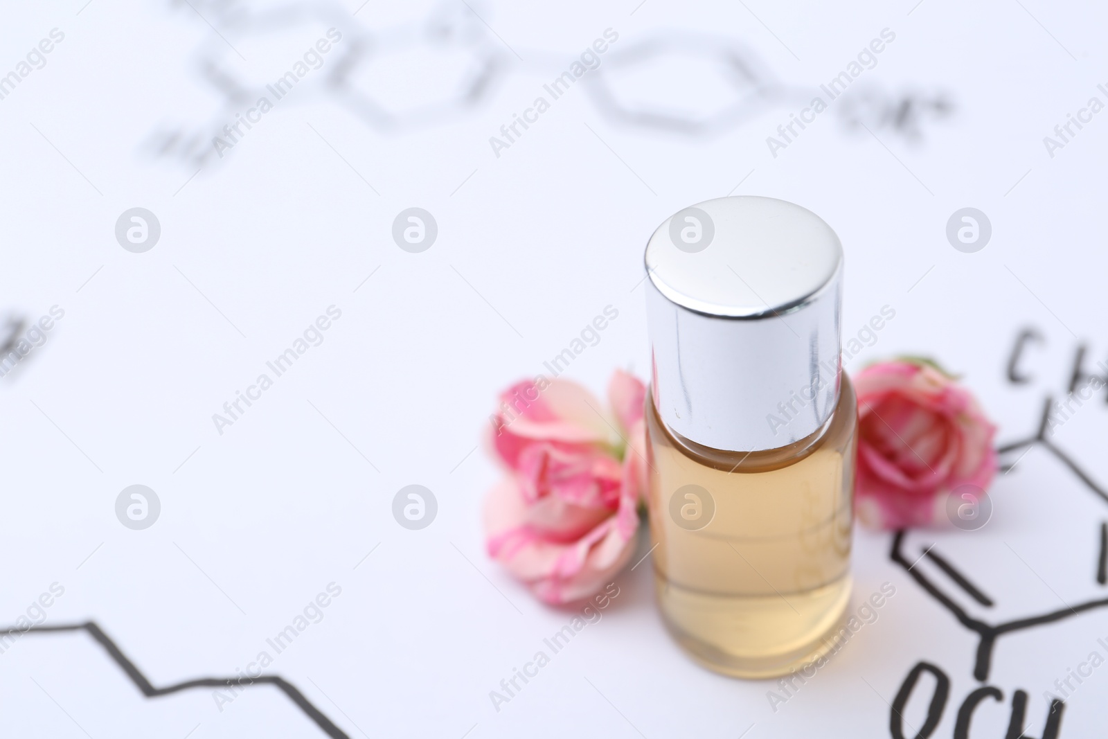 Photo of Bottle of cosmetic product and roses on paper with chemical formulas, closeup. Space for text