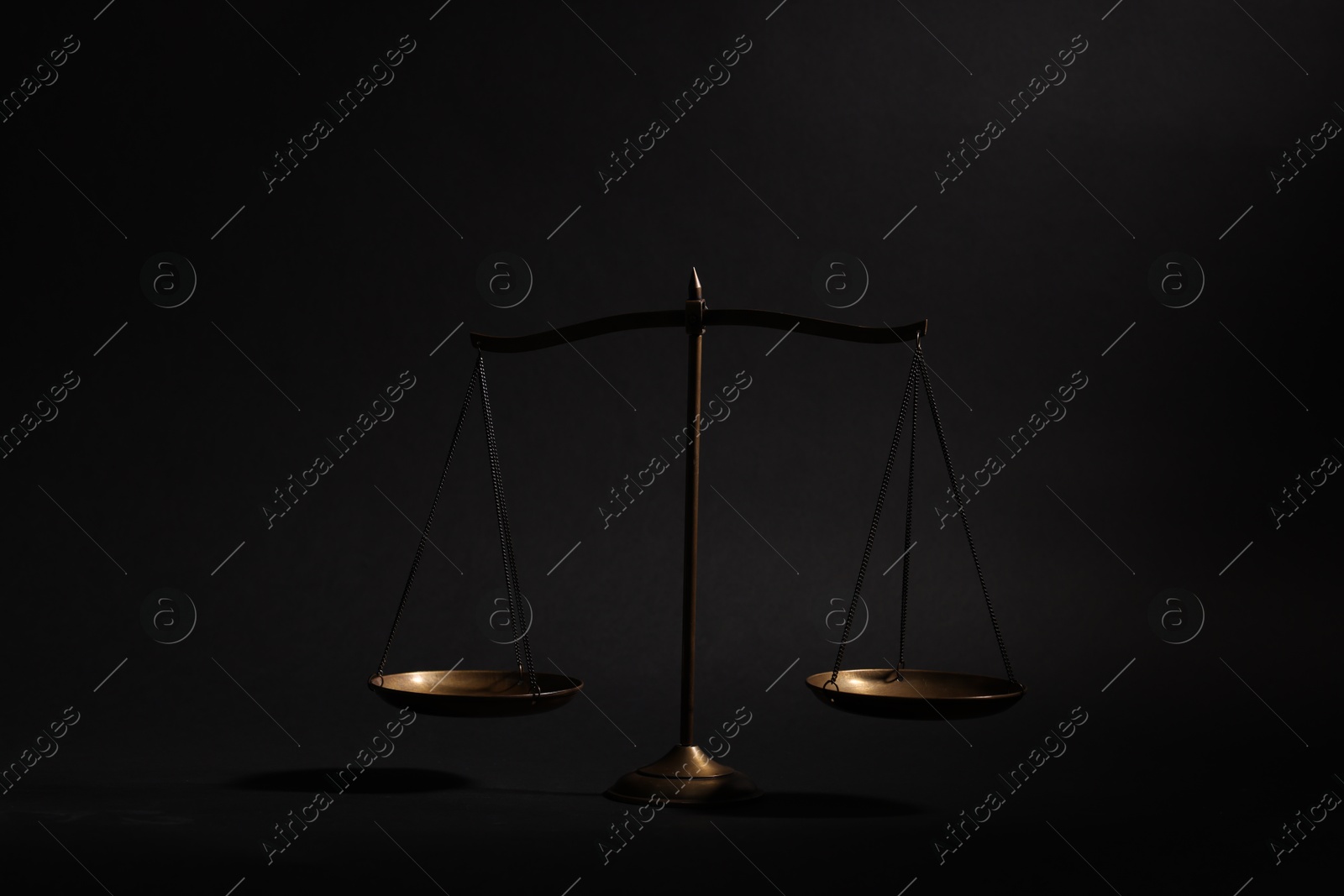 Golden scales of justice on black background Photo of Golden scales of justice on black background