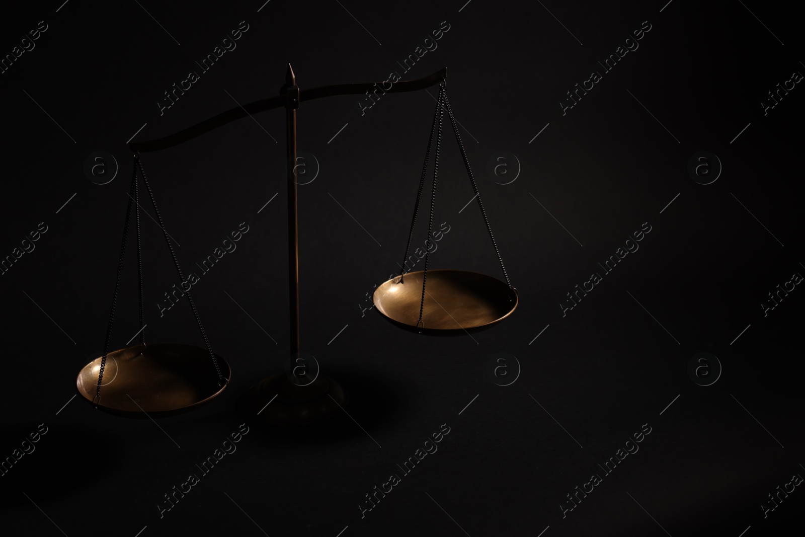 Golden scales of justice on black background Photo of Golden scales of justice on black background