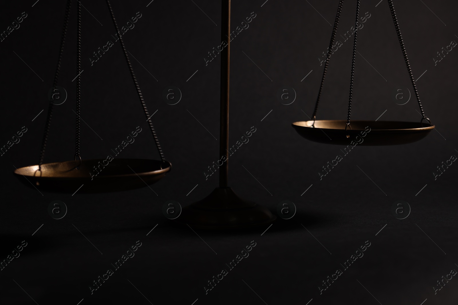 Golden scales of justice on black background, closeup Photo of Golden scales of justice on black background, closeup