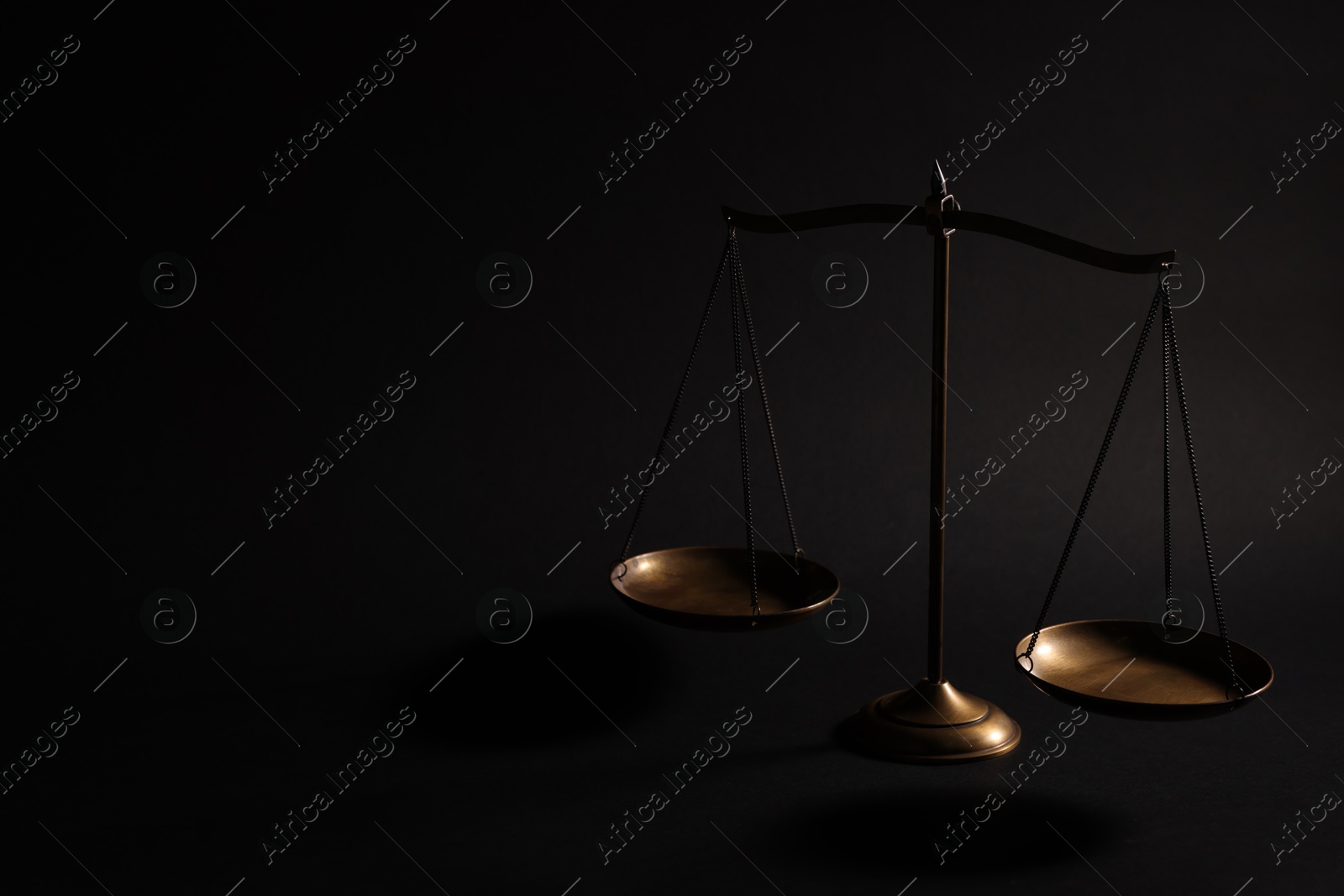 Golden scales of justice on black background, space for text Photo of Golden scales of justice on black background, space for text