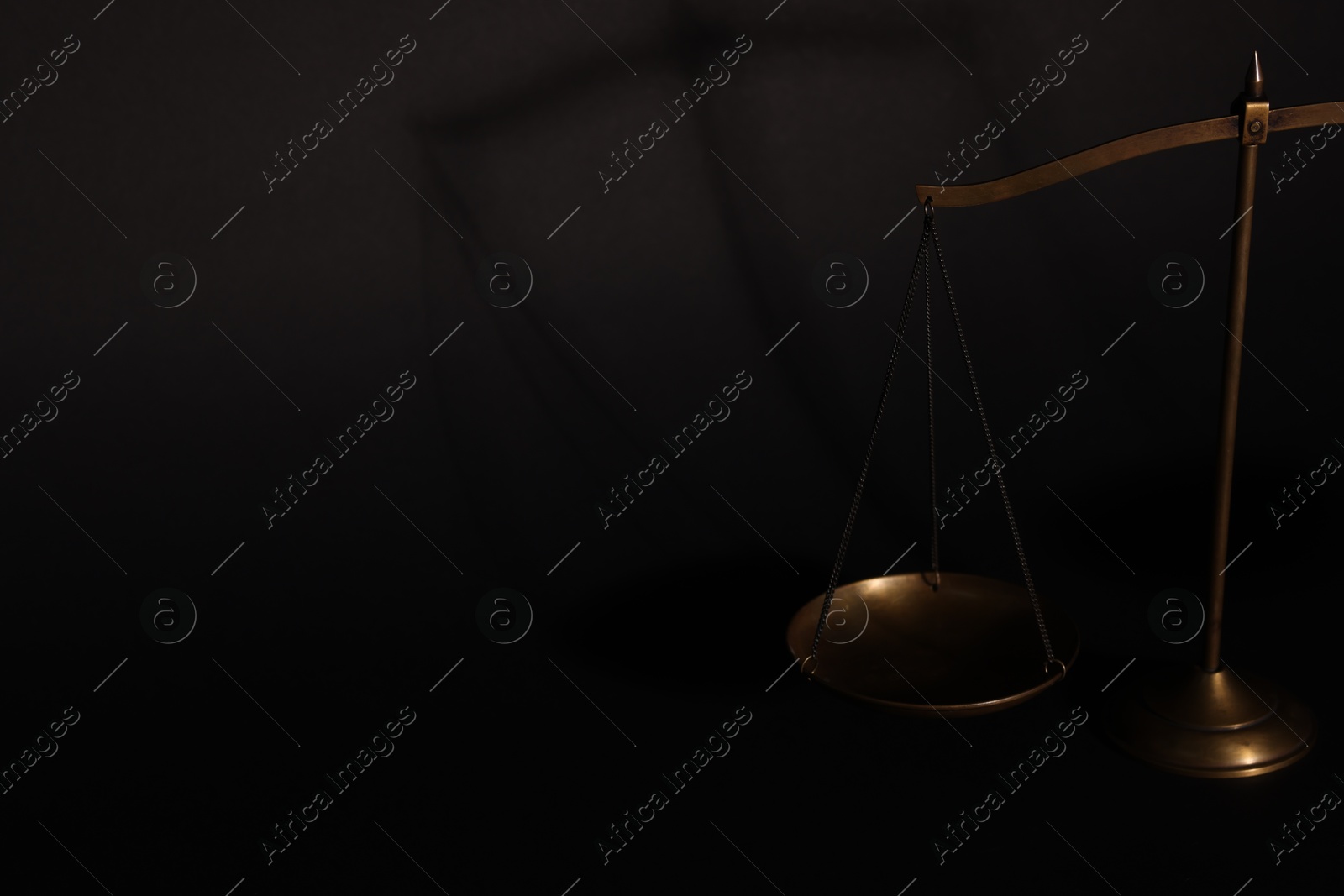 Golden scales of justice on black background, closeup. Space for text Photo of Golden scales of justice on black background, closeup. Space for text