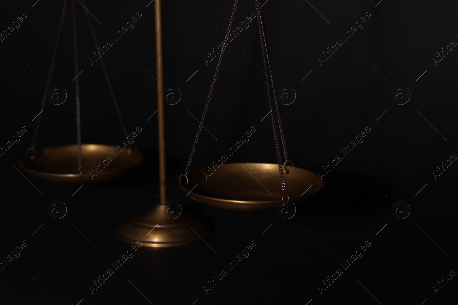 Golden scales of justice on black background, closeup Photo of Golden scales of justice on black background, closeup