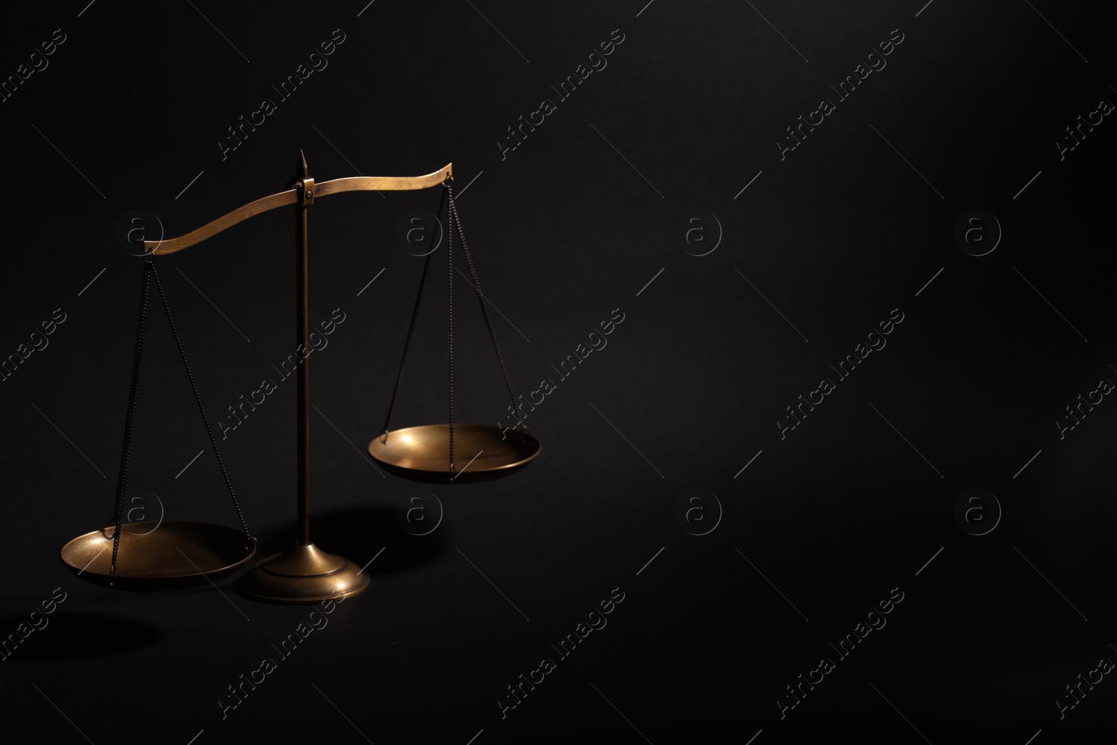 Golden scales of justice on black background, space for text Photo of Golden scales of justice on black background, space for text
