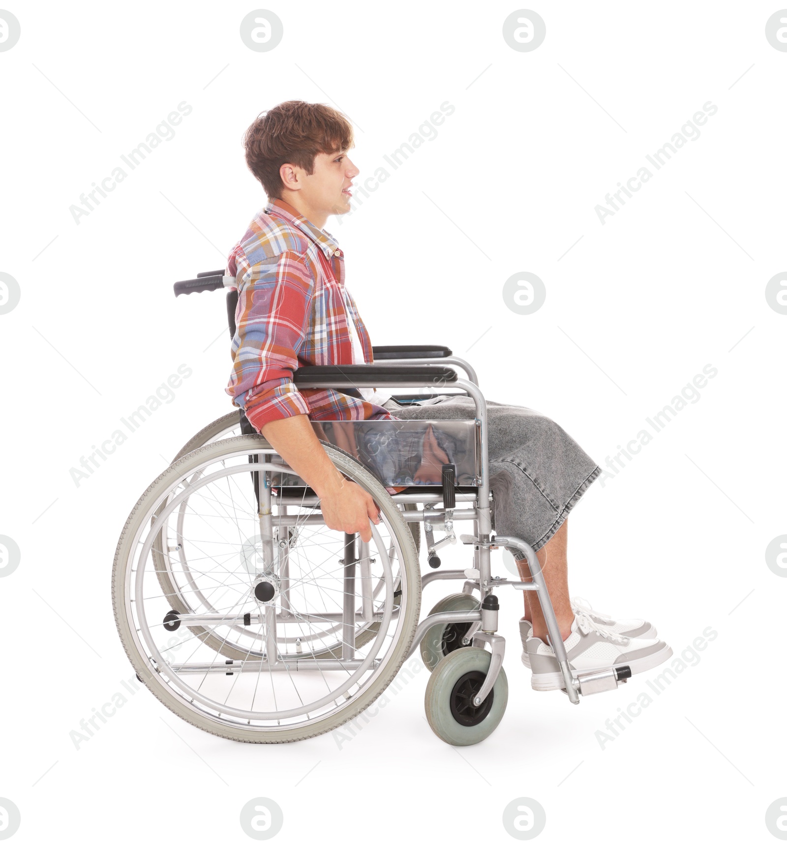 Photo of Teenage boy in wheelchair on white background