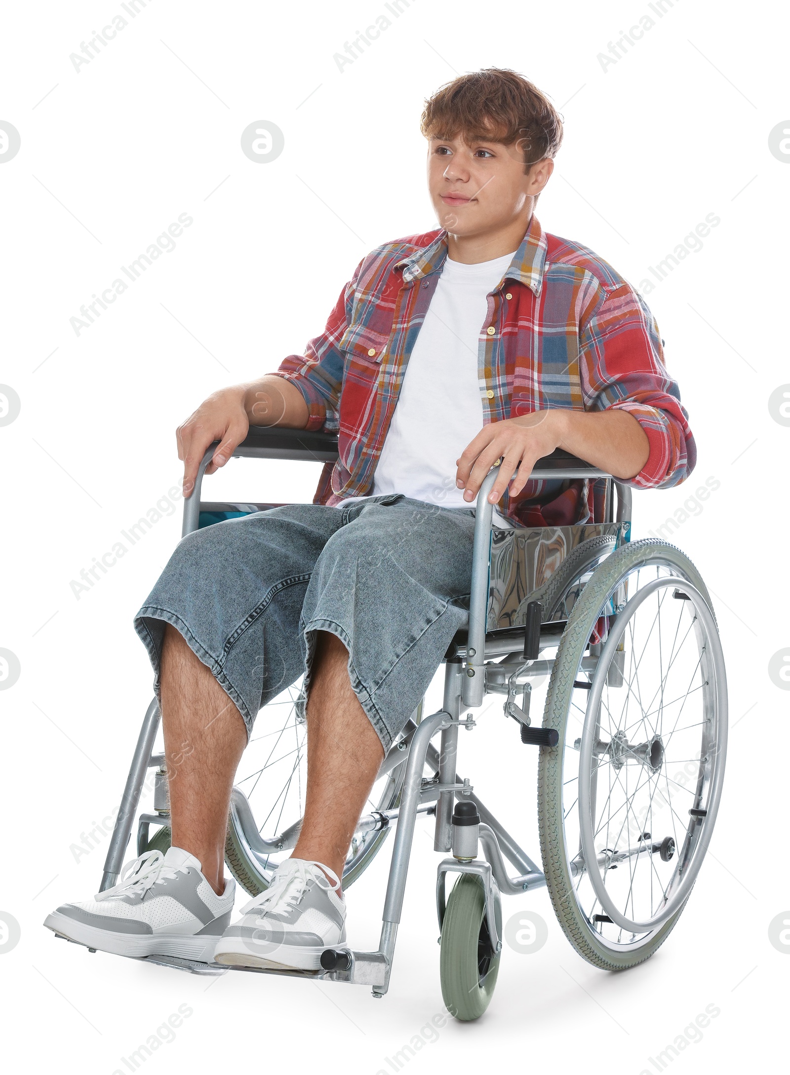 Photo of Teenage boy in wheelchair on white background