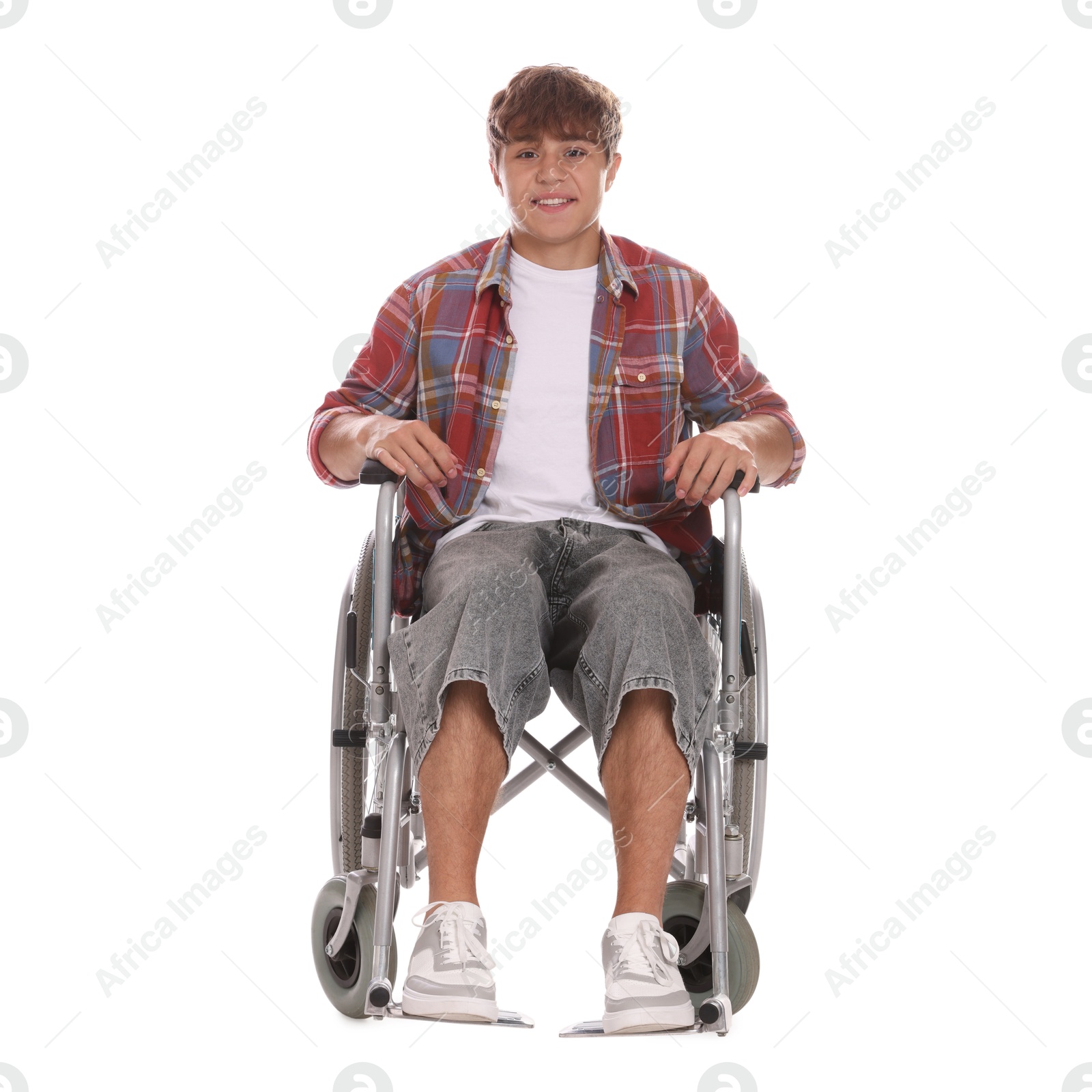 Photo of Smiling teenage boy in wheelchair on white background