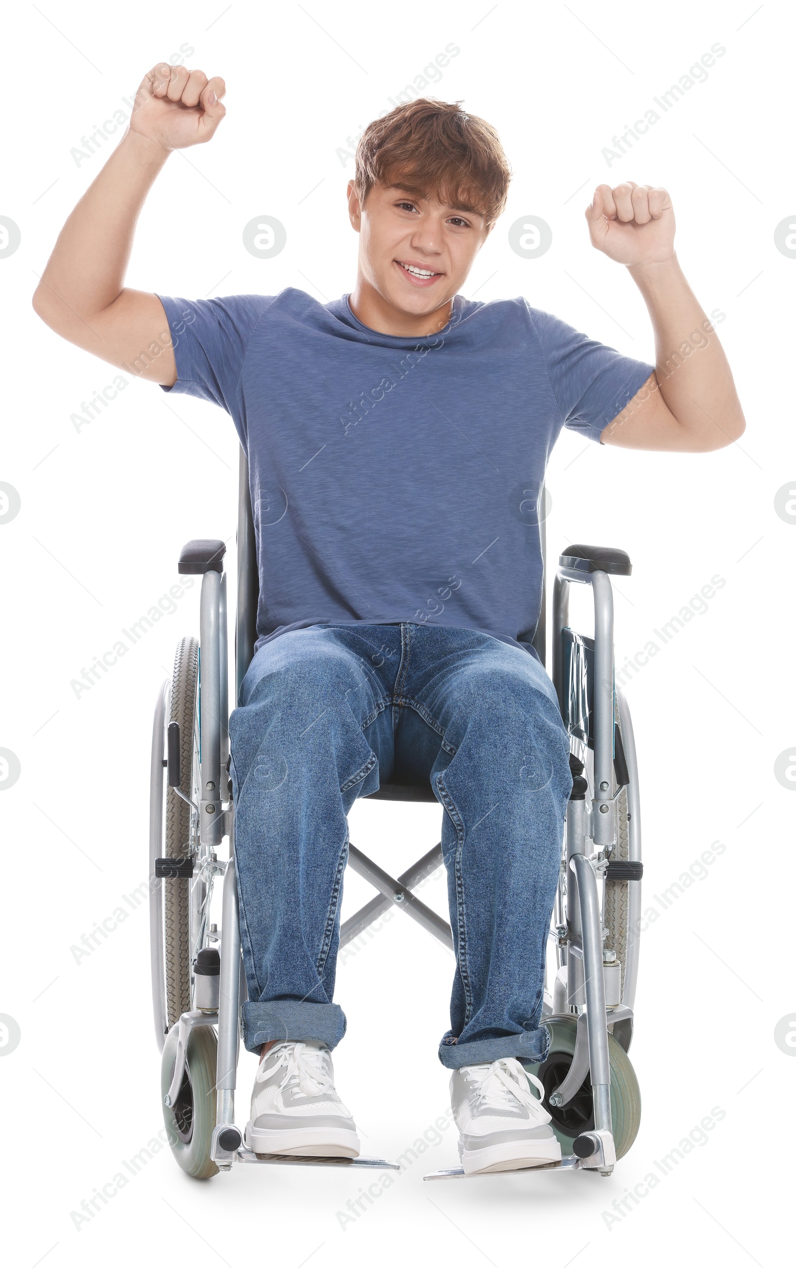 Photo of Smiling teenage boy in wheelchair on white background