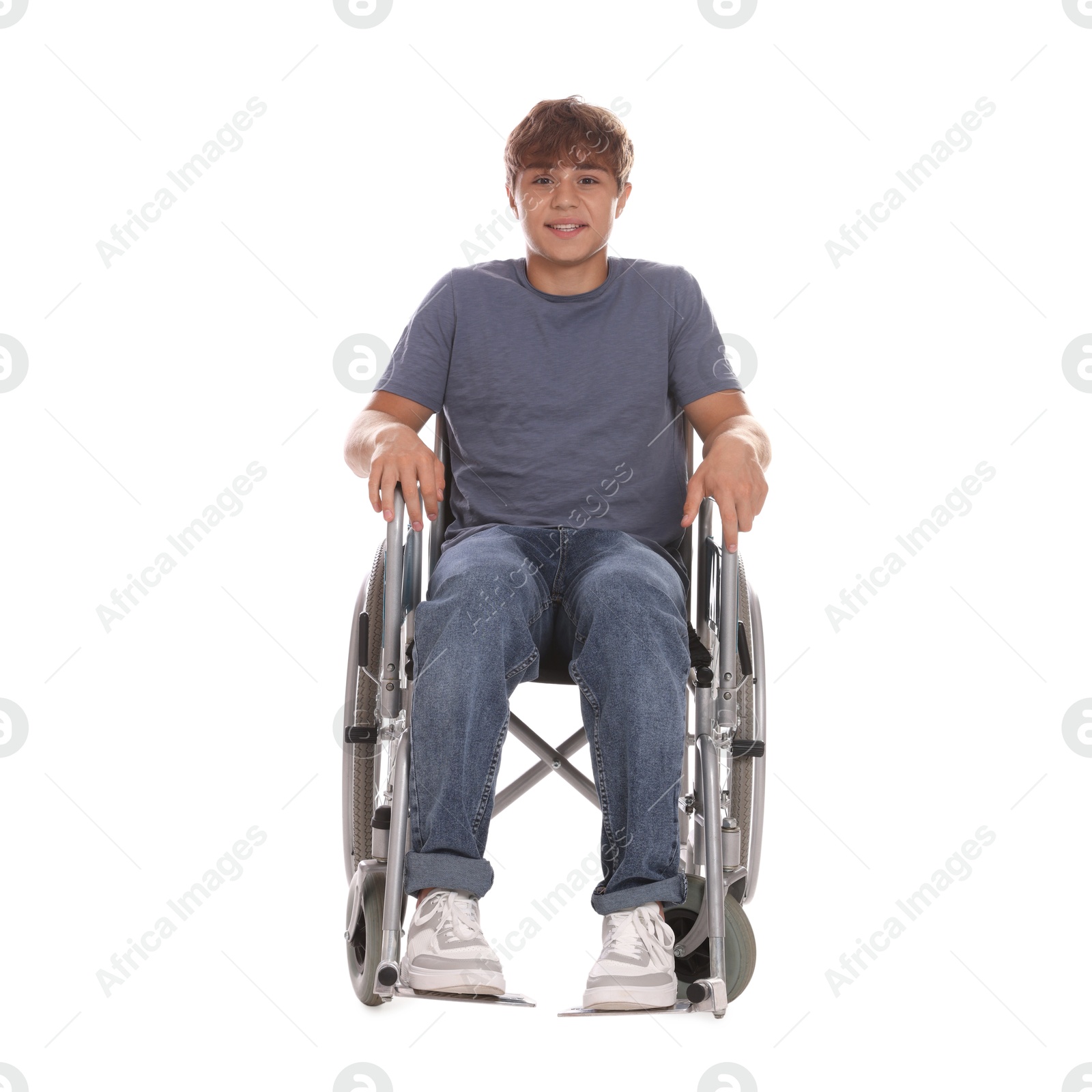 Photo of Smiling teenage boy in wheelchair on white background