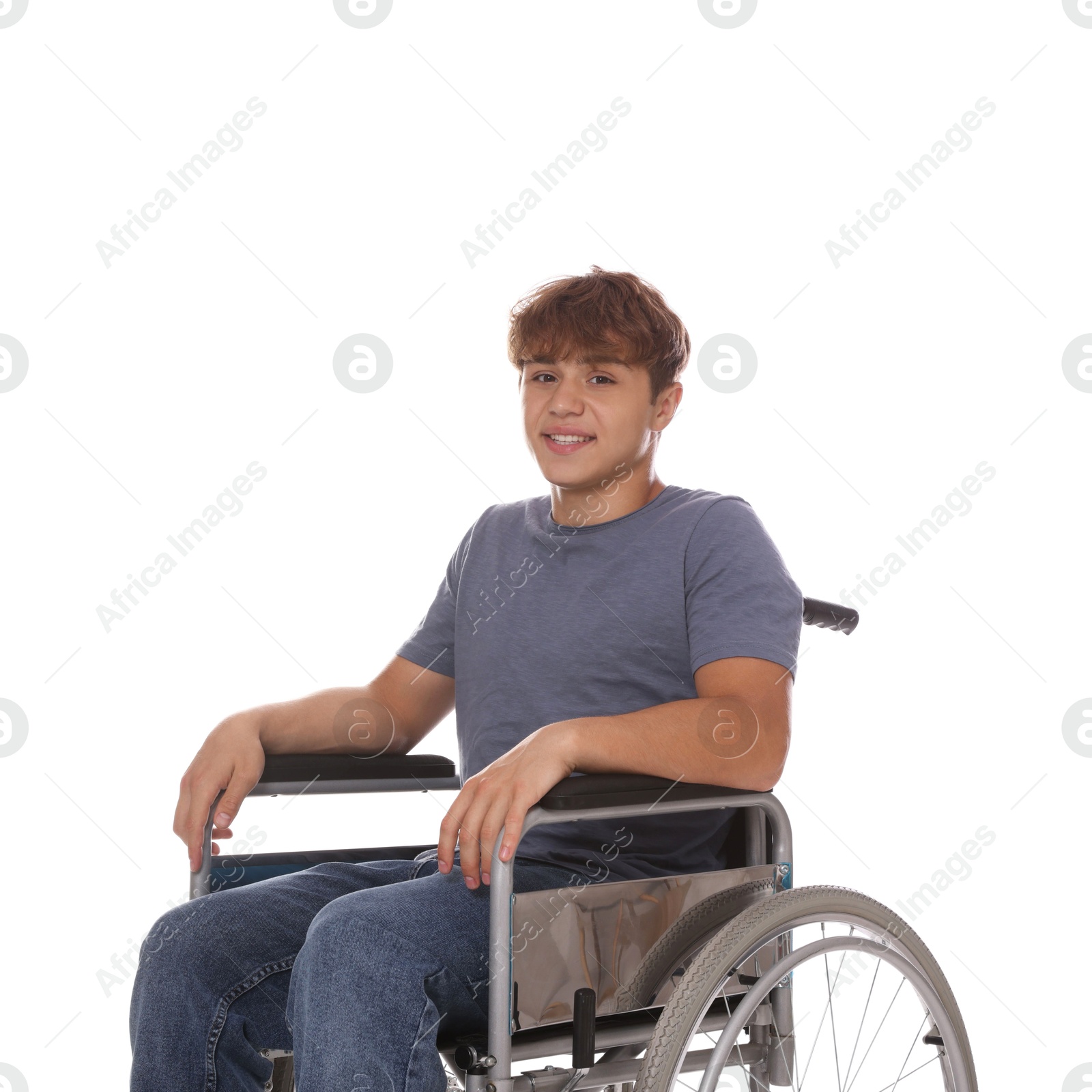 Photo of Smiling teenage boy in wheelchair on white background
