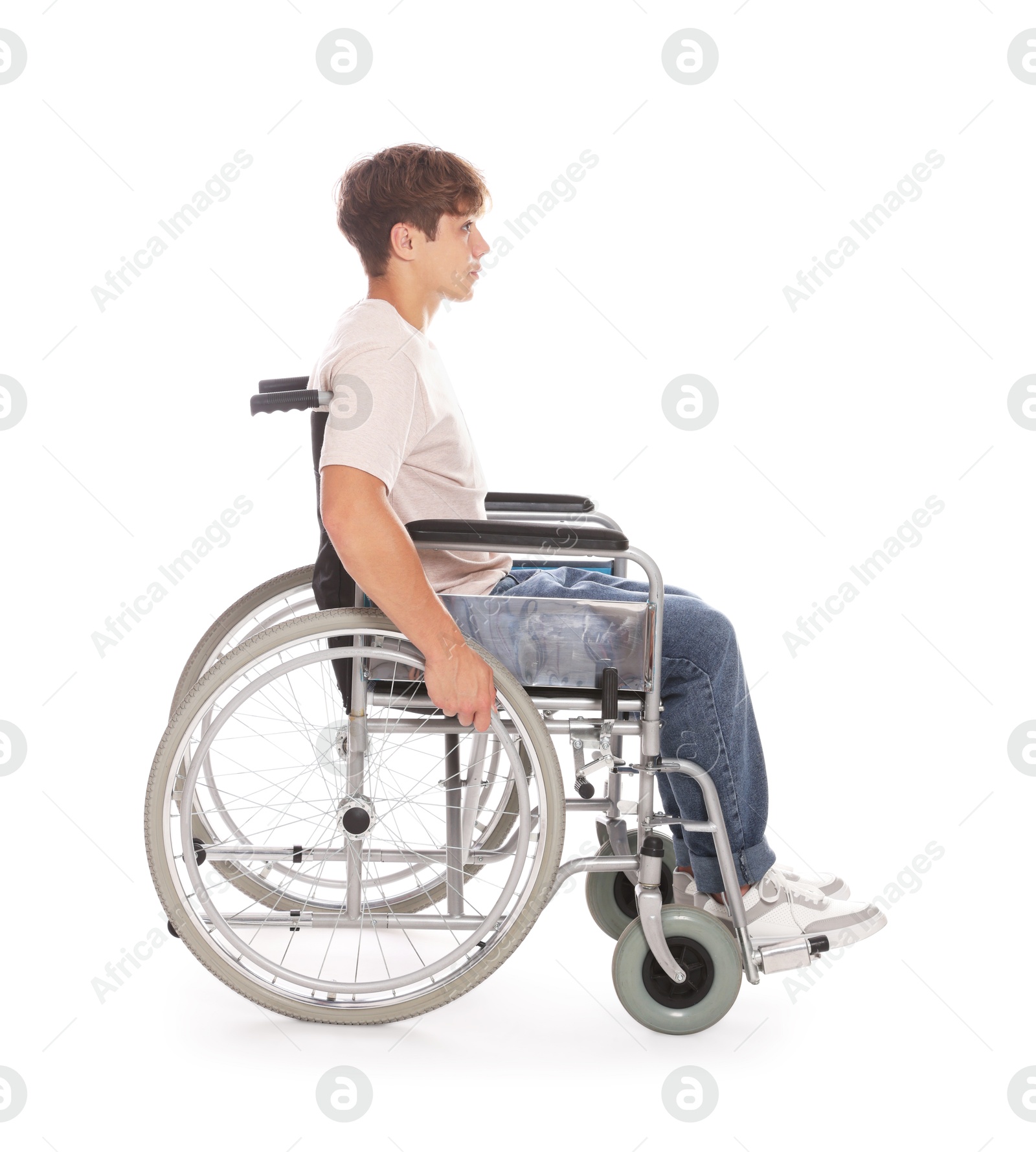 Photo of Teenage boy in wheelchair on white background