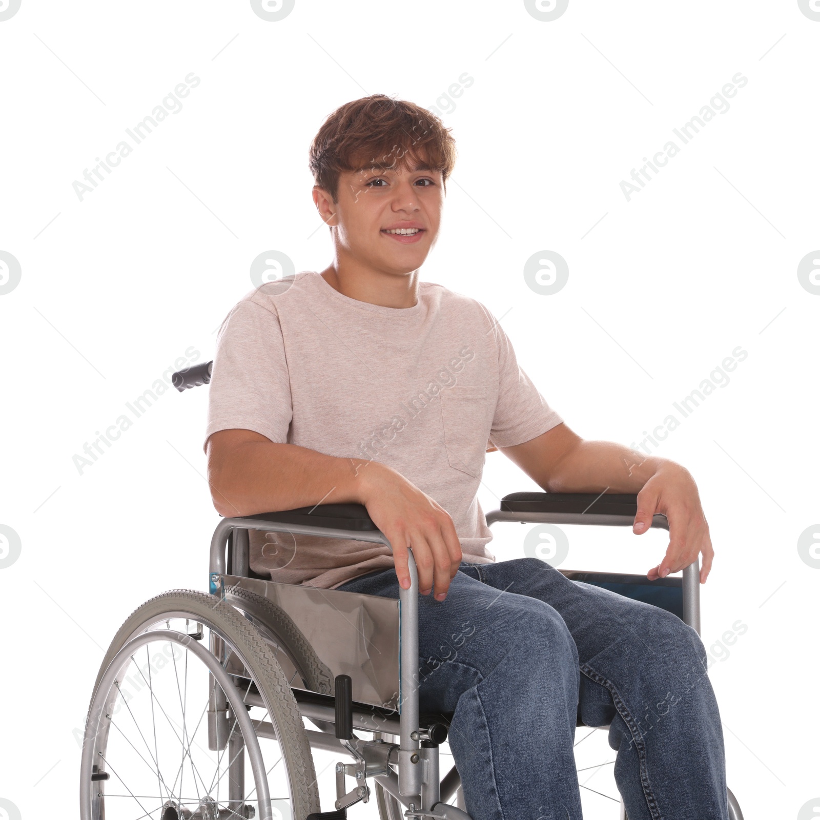 Photo of Smiling teenage boy in wheelchair on white background