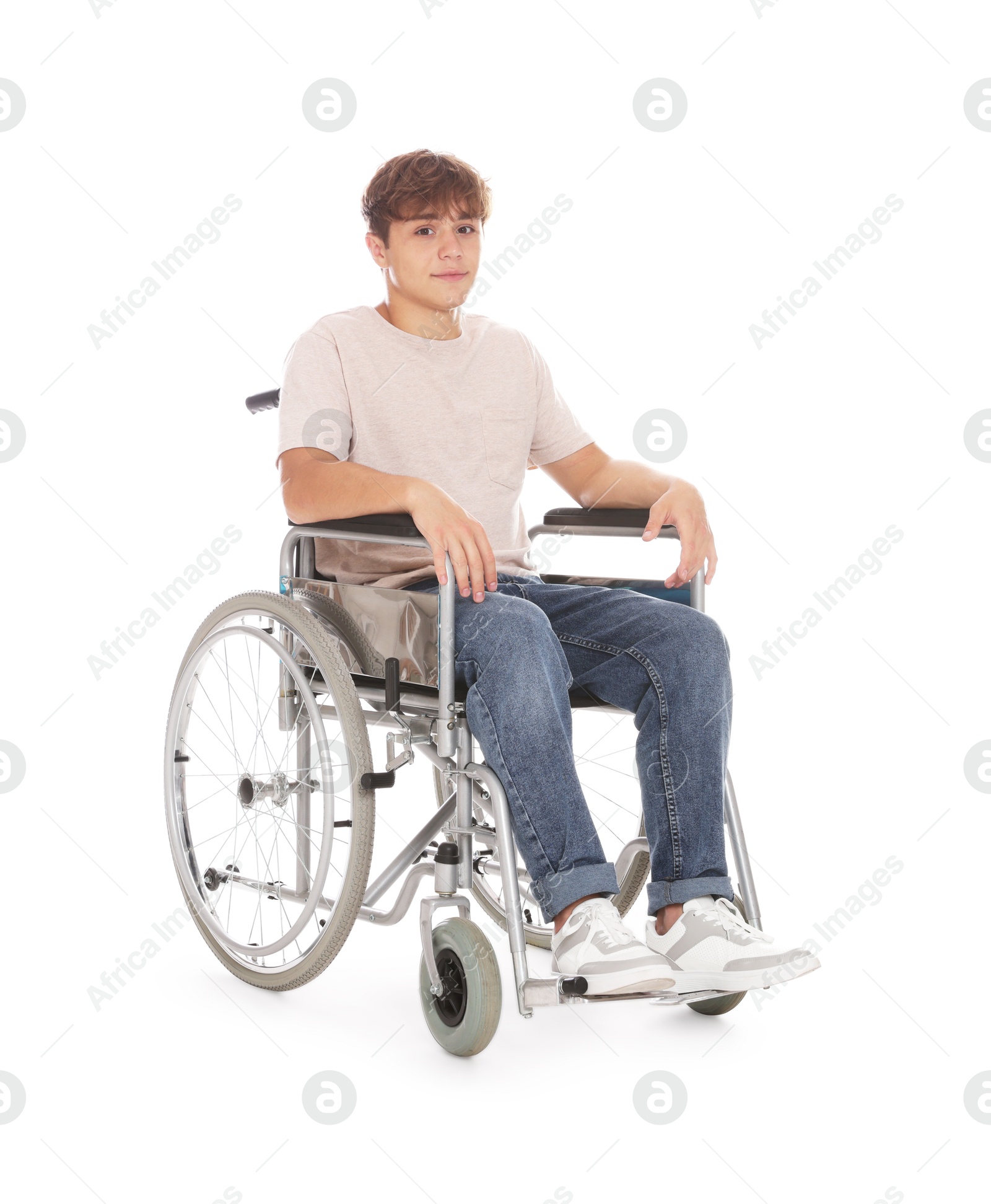 Photo of Teenage boy in wheelchair on white background