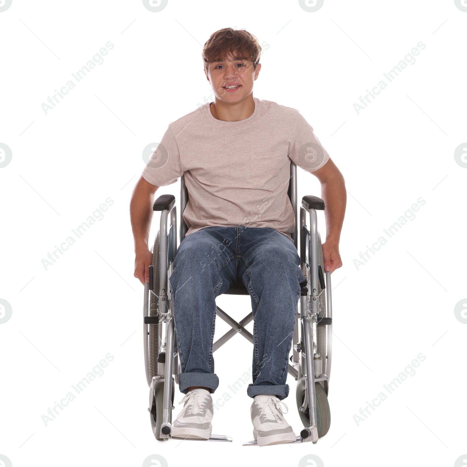 Photo of Smiling teenage boy in wheelchair on white background