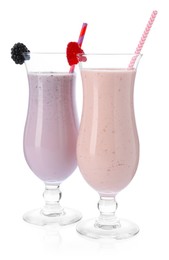 Photo of Different tasty milkshakes in glasses isolated on white