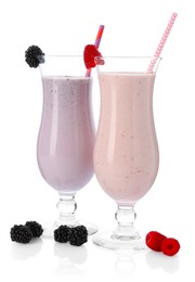 Photo of Different tasty milkshakes in glasses and ingredients isolated on white