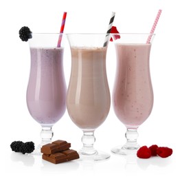 Photo of Different tasty milkshakes in glasses and ingredients isolated on white