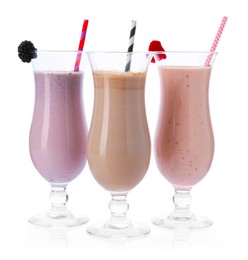 Photo of Different tasty milkshakes in glasses isolated on white