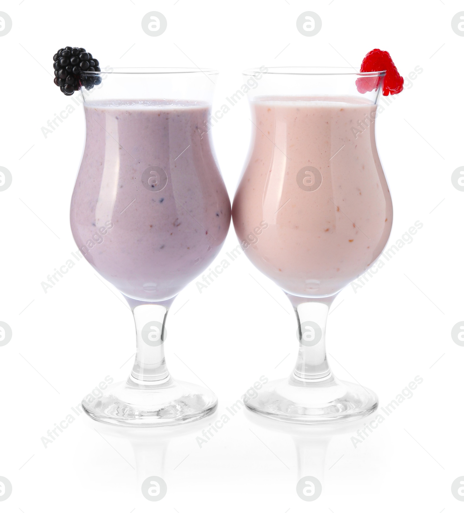 Photo of Different tasty milkshakes in glasses isolated on white