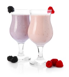 Photo of Different tasty milkshakes in glasses and ingredients isolated on white