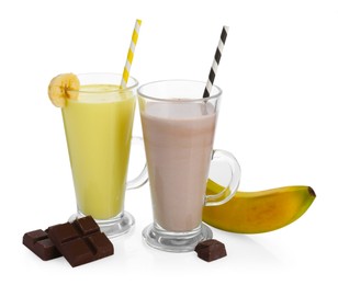 Photo of Different tasty milkshakes in glasses and ingredients isolated on white