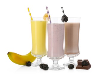 Photo of Different tasty milkshakes in glasses and ingredients isolated on white