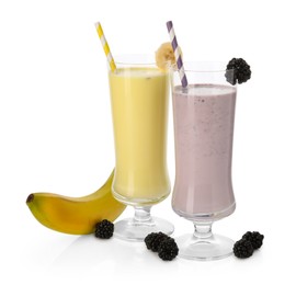 Photo of Different tasty milkshakes in glasses and ingredients isolated on white