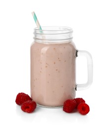 Photo of Tasty raspberry milkshake in mason jar and berries isolated on white