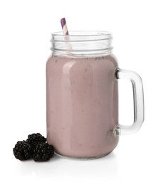 Photo of Tasty blackberry milkshake in mason jar and berries isolated on white