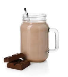 Photo of Tasty milkshake in mason jar and pieces of chocolate isolated on white