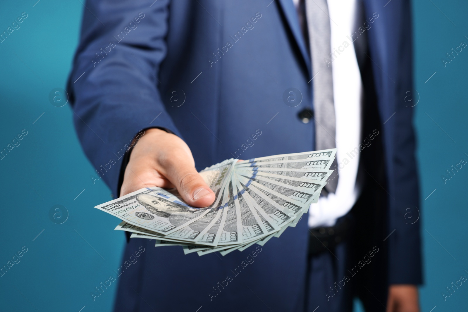 Man with dollar bills on blue background, closeup Photo of Man with dollar bills on blue background, closeup
