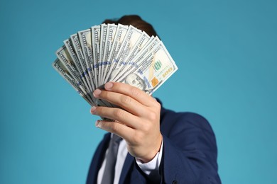 Photo of Man with dollar bills on blue background