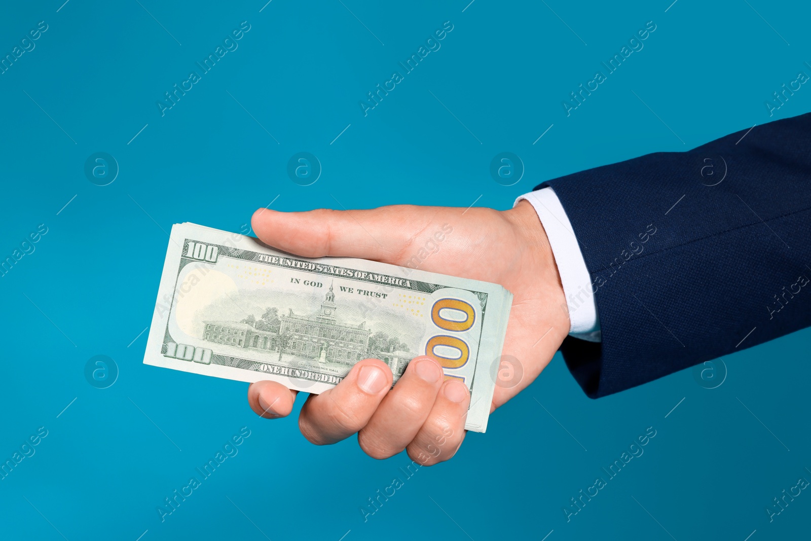 Man with dollar bills on blue background, closeup Photo of Man with dollar bills on blue background, closeup