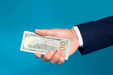 Photo of Man with dollar bills on blue background, closeup