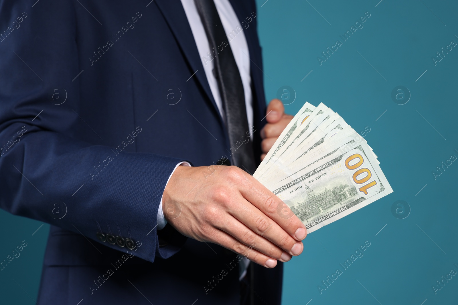 Man with dollar bills on blue background, closeup Photo of Man with dollar bills on blue background, closeup
