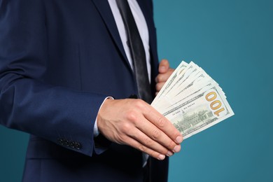 Photo of Man with dollar bills on blue background, closeup