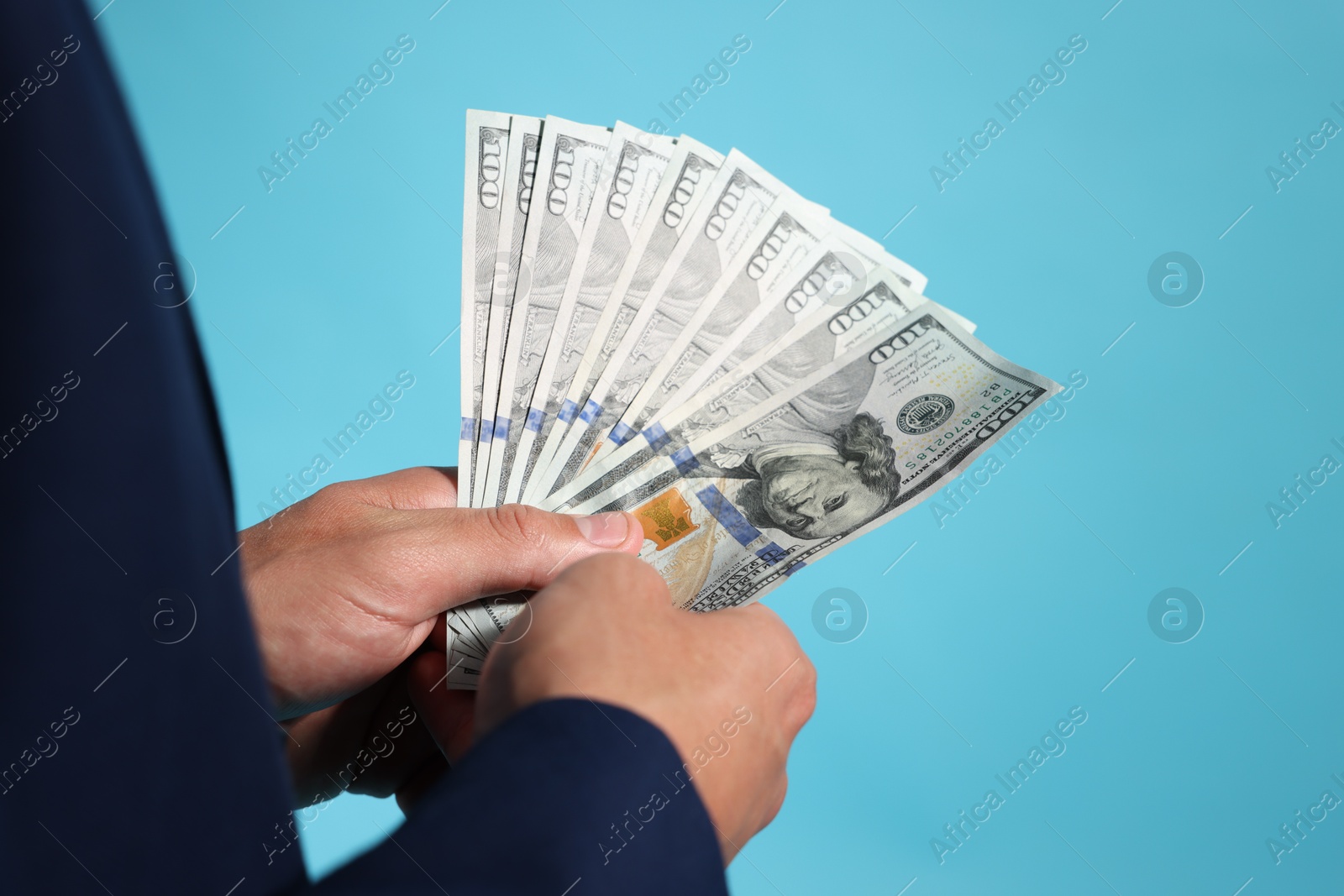 Man with dollar bills on blue background, closeup Photo of Man with dollar bills on blue background, closeup
