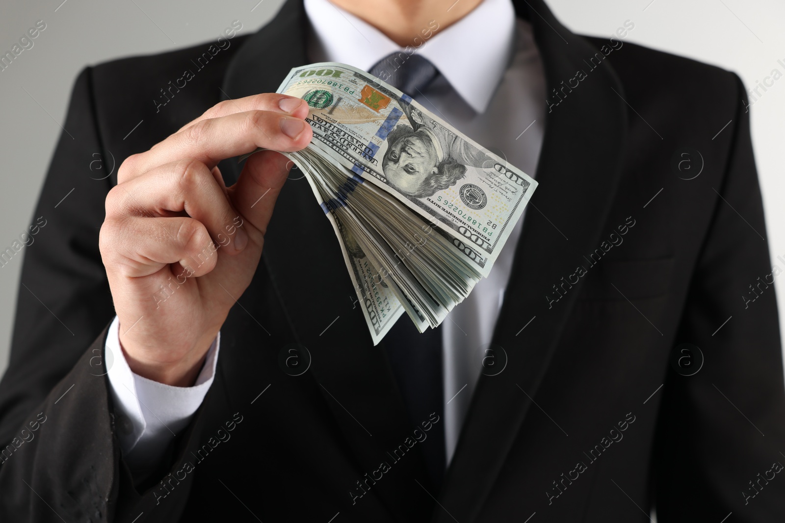 Man with dollar bills on light background, closeup Photo of Man with dollar bills on light background, closeup