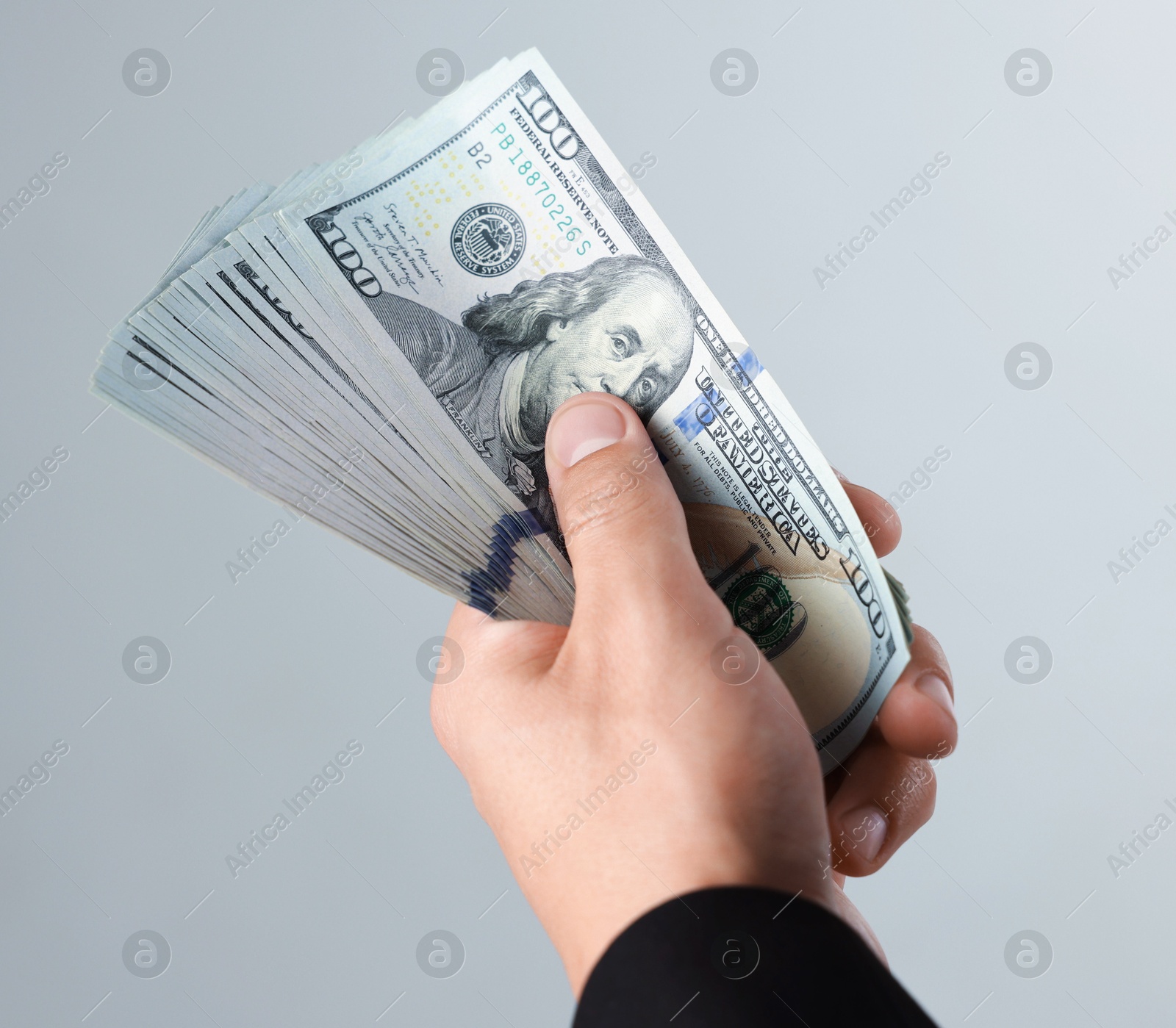 Man with dollar bills on light background, closeup Photo of Man with dollar bills on light background, closeup