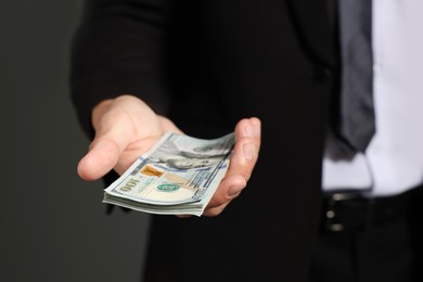 Photo of Man with dollar bills on grey background, closeup