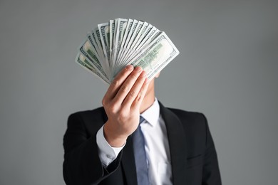 Photo of Man with dollar bills on grey background