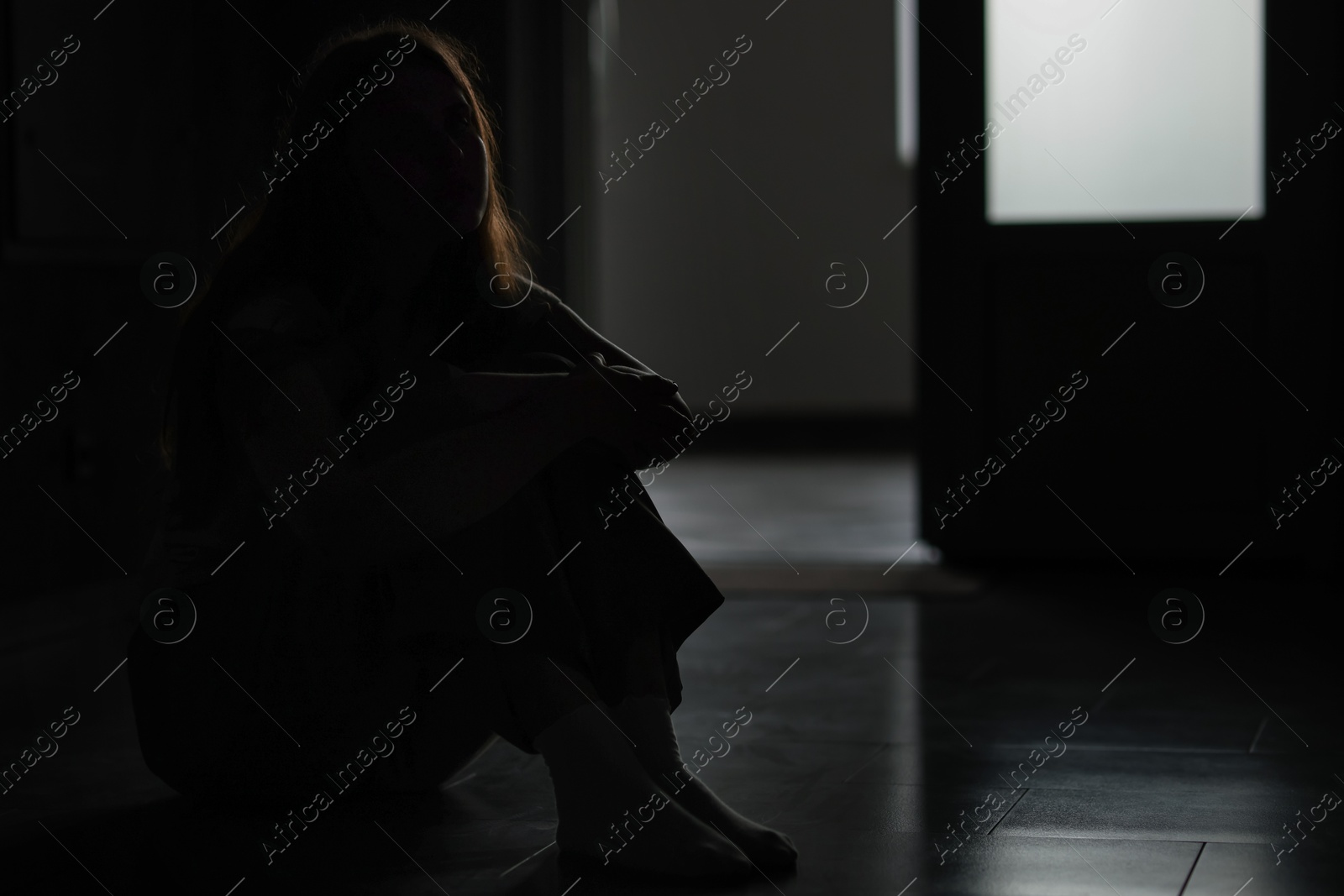 Silhouette of sad young woman at home, space for text Photo of Silhouette of sad young woman at home, space for text