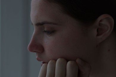 Photo of Sad young woman at home, closeup. Depression concept